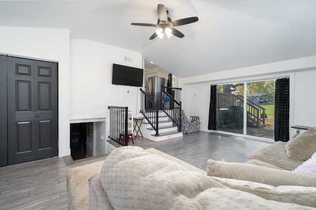 living room with vaulted ceiling, hardwood / wood-style flooring, and ceiling fan