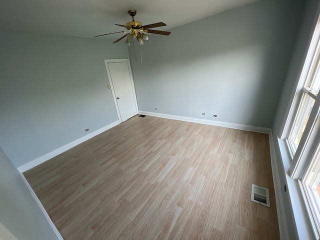 empty room featuring light hardwood / wood-style flooring and ceiling fan