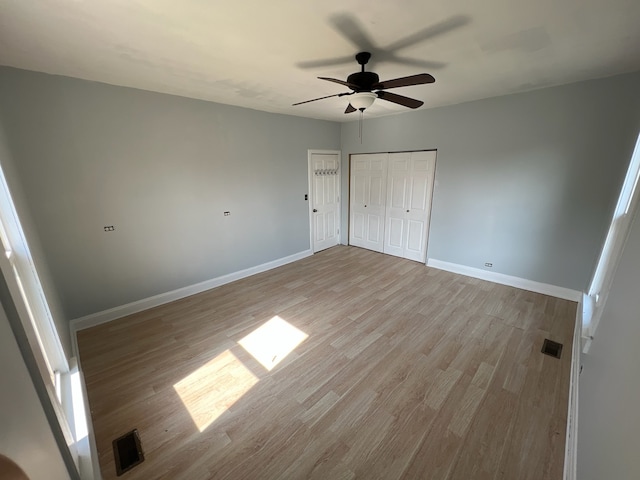 unfurnished bedroom featuring ceiling fan and light wood-type flooring