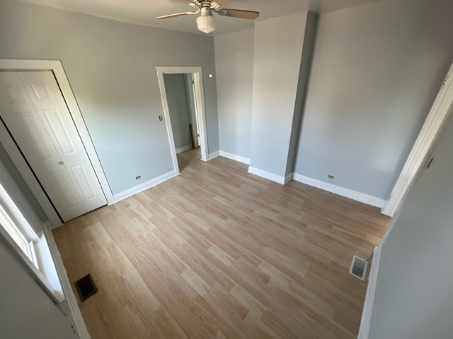 unfurnished bedroom with ceiling fan and light hardwood / wood-style flooring