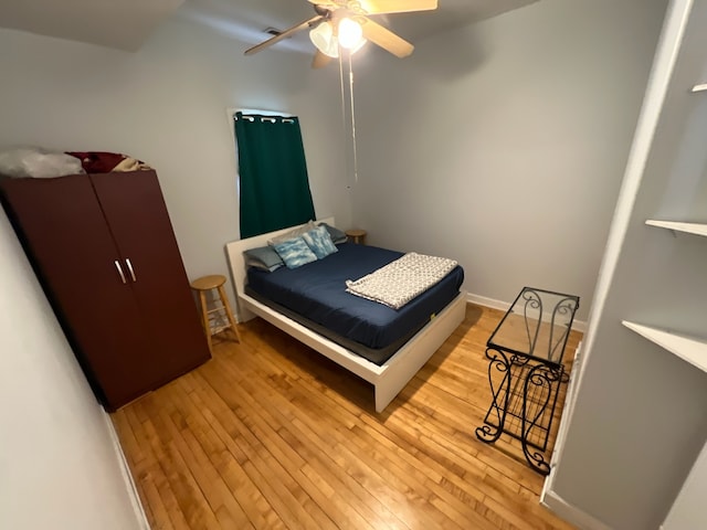 bedroom with light wood-type flooring and ceiling fan