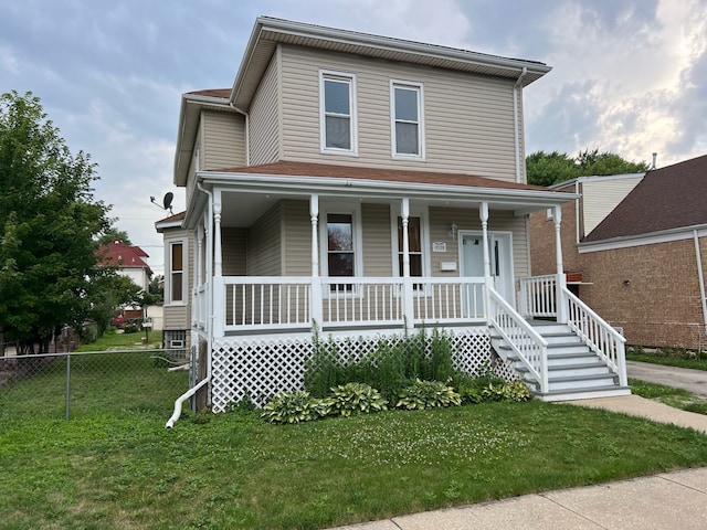 view of front facade featuring covered porch and a front lawn