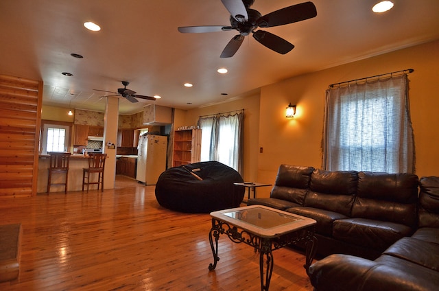 living room with ceiling fan and light hardwood / wood-style floors