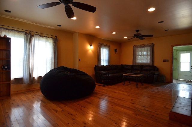 living room with wood-type flooring and ceiling fan