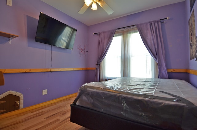 bedroom with ceiling fan and hardwood / wood-style flooring