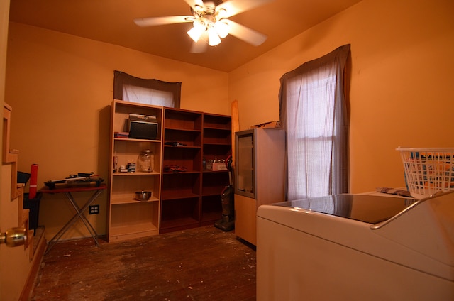 interior space with ceiling fan, dark hardwood / wood-style floors, washer / dryer, and vaulted ceiling