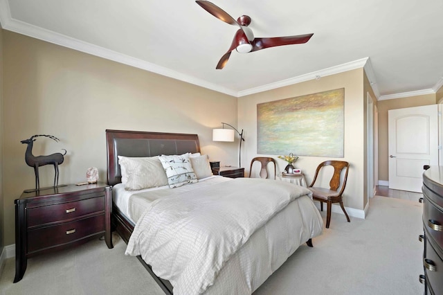 carpeted bedroom featuring ceiling fan and ornamental molding