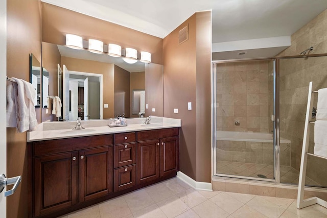 bathroom with vanity, tile patterned flooring, and an enclosed shower