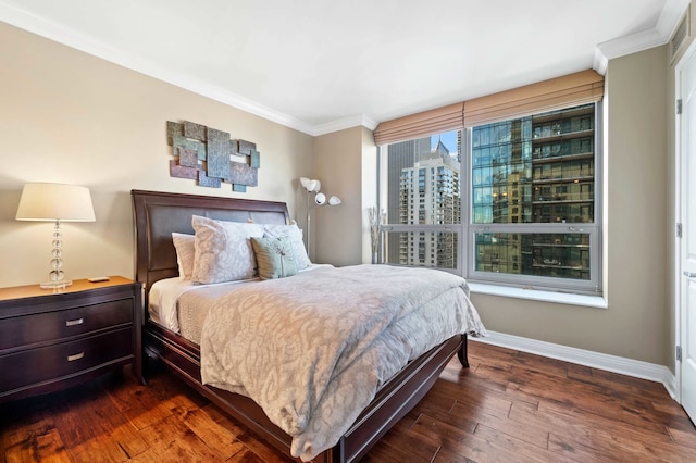 bedroom with ornamental molding and dark wood-type flooring