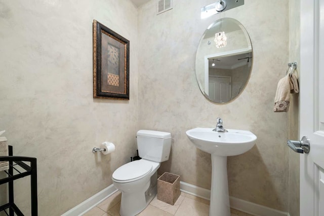 bathroom featuring toilet and tile patterned flooring