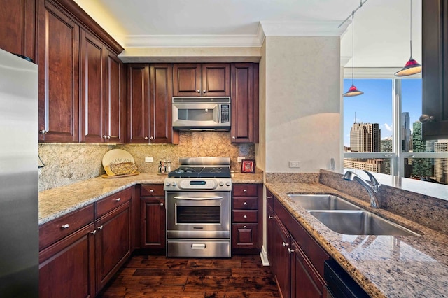 kitchen featuring light stone counters, appliances with stainless steel finishes, ornamental molding, dark wood-type flooring, and decorative light fixtures