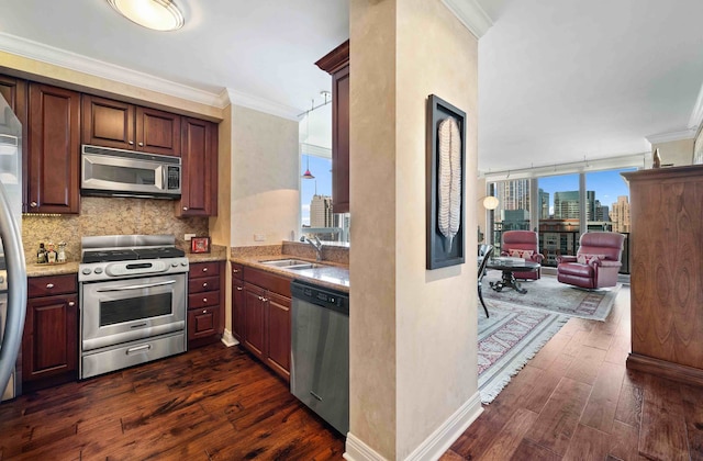 kitchen with appliances with stainless steel finishes, sink, crown molding, decorative backsplash, and dark hardwood / wood-style floors