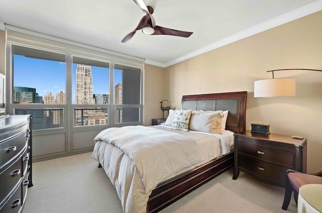 carpeted bedroom with ceiling fan and crown molding