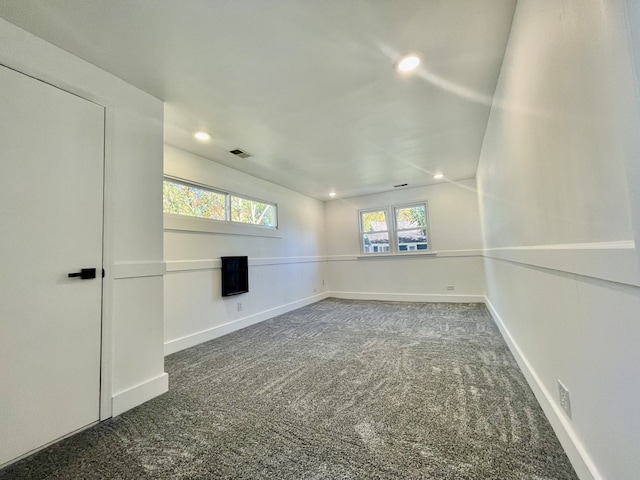 empty room with dark colored carpet