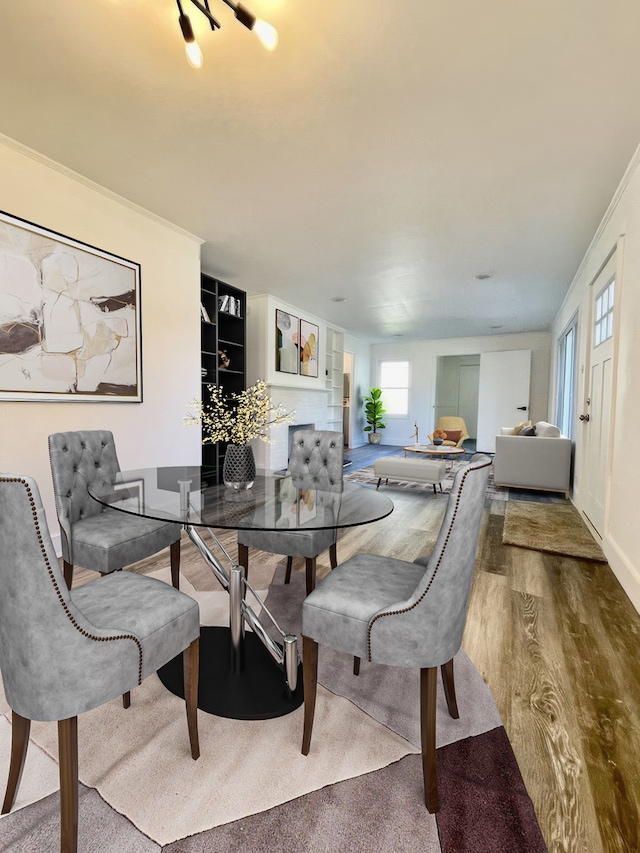 dining space featuring crown molding and hardwood / wood-style flooring