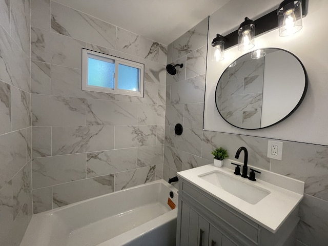 bathroom featuring vanity, tiled shower / bath combo, and tile walls