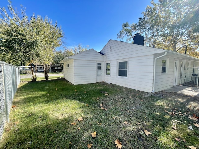 rear view of house with a yard