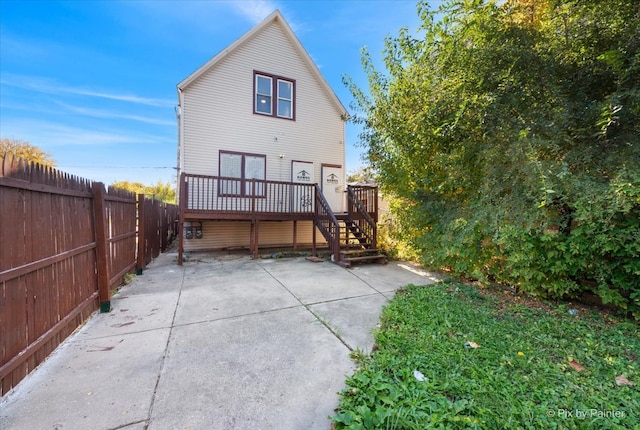 rear view of house with a patio and a wooden deck