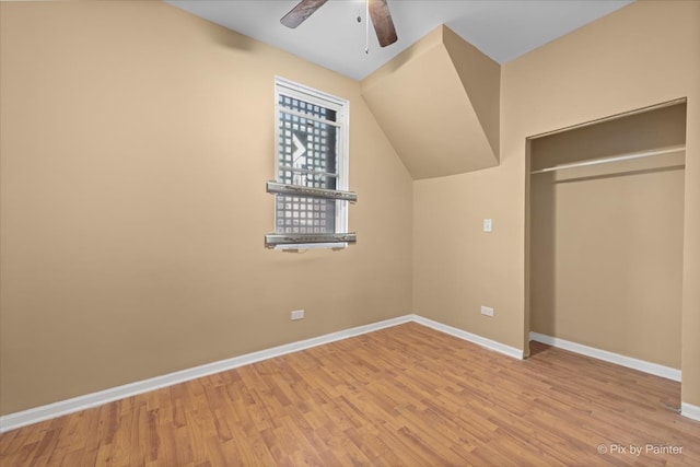 unfurnished bedroom featuring light hardwood / wood-style floors, a closet, and ceiling fan