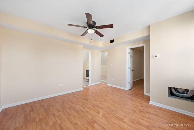 empty room featuring light hardwood / wood-style flooring and ceiling fan