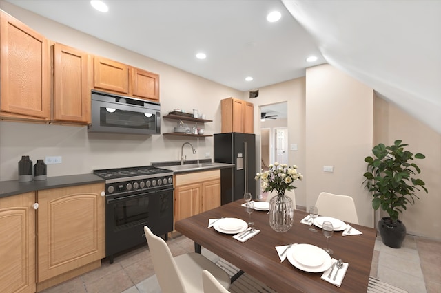 kitchen with ceiling fan, light tile patterned floors, light brown cabinetry, black appliances, and sink