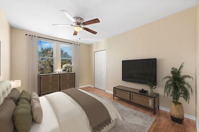 bedroom featuring wood-type flooring, a closet, and ceiling fan