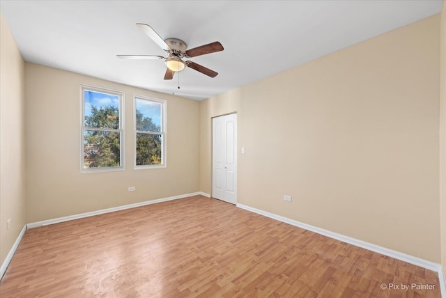 empty room with light wood-type flooring and ceiling fan