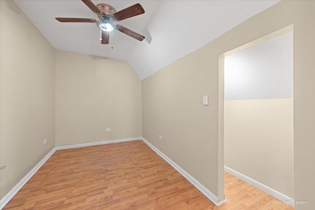 spare room with lofted ceiling, light wood-type flooring, and ceiling fan