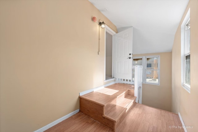 corridor with light hardwood / wood-style flooring