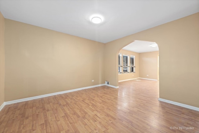 spare room with light hardwood / wood-style flooring