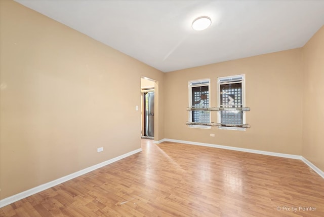 spare room with light hardwood / wood-style flooring