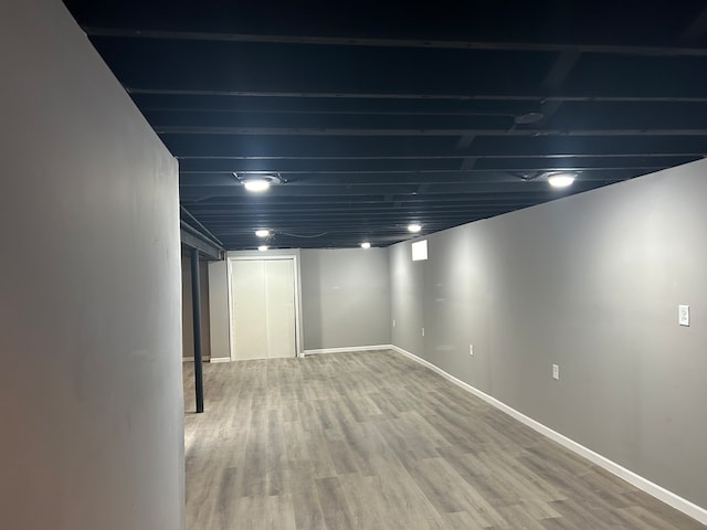 basement with hardwood / wood-style flooring