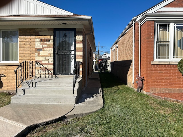 entrance to property with a yard