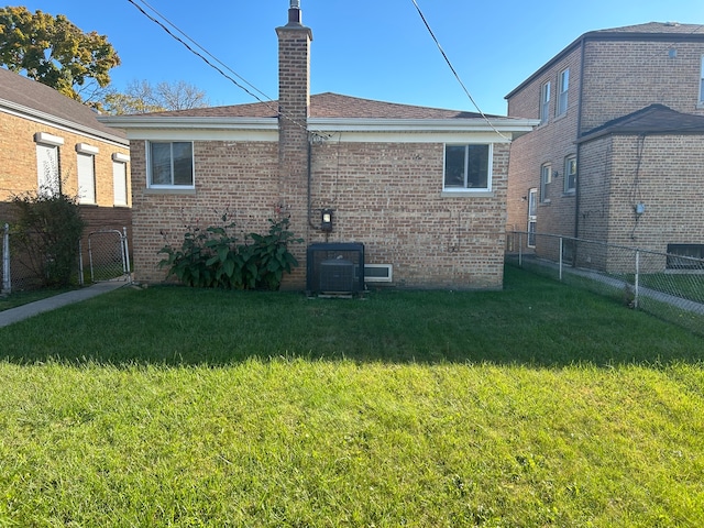 rear view of property with a yard