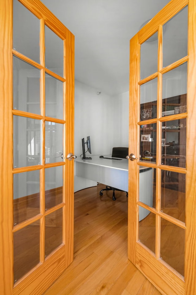 unfurnished office with french doors and wood-type flooring