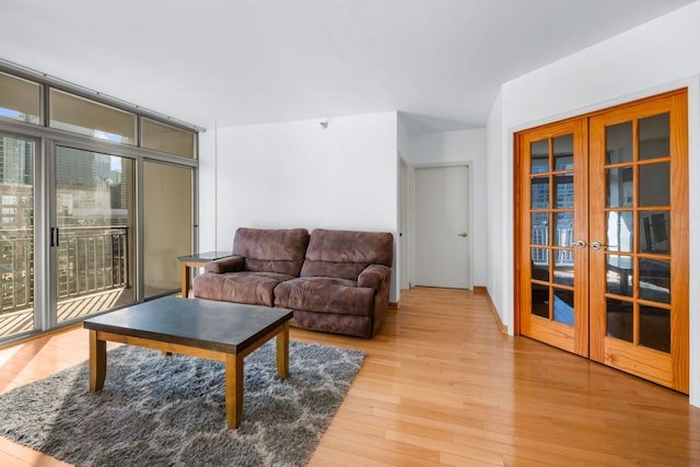 living room featuring french doors and light hardwood / wood-style floors