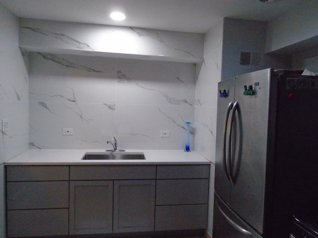 8252 N Octavia Ave, Niles, IL 60714 - kitchen with a sink, light countertops, gray cabinets, freestanding refrigerator, and tile walls
