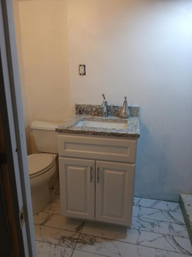8252 N Octavia Ave, Niles, IL 60714 - bathroom with vanity, toilet, and marble finish floor