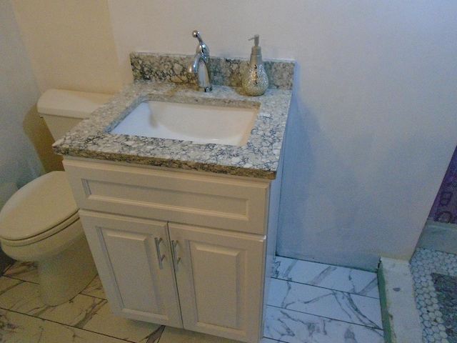 8252 N Octavia Ave, Niles, IL 60714 - half bath featuring vanity, marble finish floor, and toilet