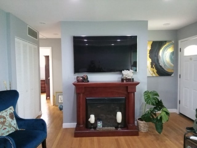 8252 N Octavia Ave, Niles, IL 60714 - living room featuring baseboards, a fireplace, wood finished floors, and visible vents