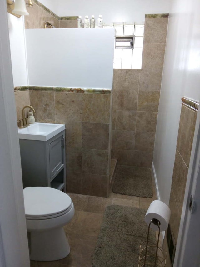 8252 N Octavia Ave, Niles, IL 60714 - full bathroom with a walk in shower, tile walls, vanity, and toilet