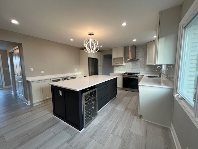 kitchen with a kitchen island, hanging light fixtures, stainless steel appliances, wall chimney exhaust hood, and wine cooler