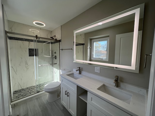 bathroom featuring vanity, toilet, and walk in shower