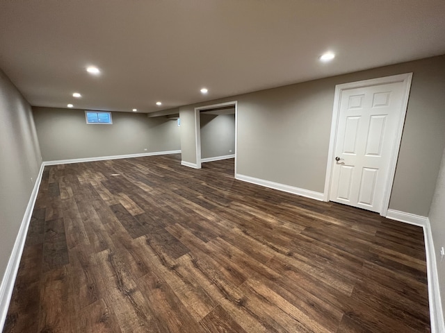 basement with dark hardwood / wood-style floors