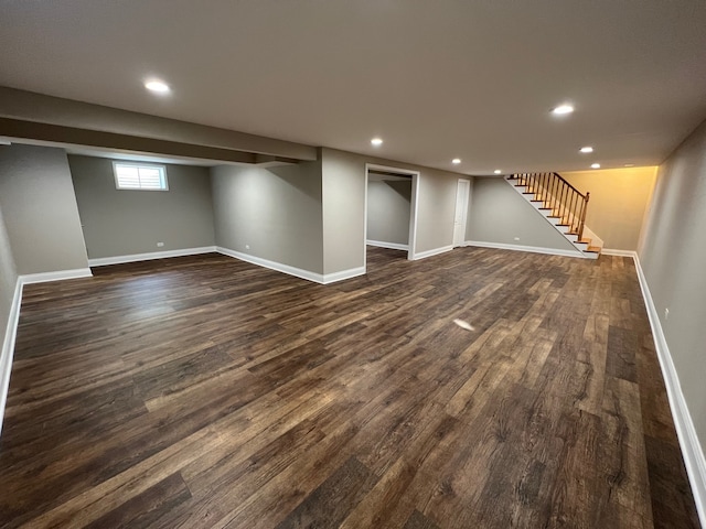 basement with dark hardwood / wood-style floors