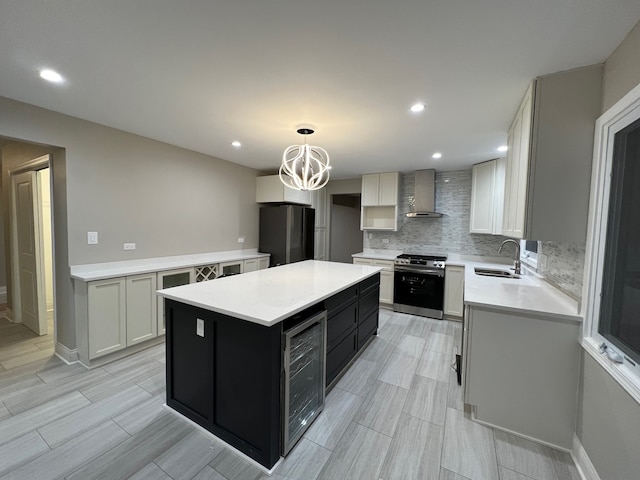 kitchen featuring a kitchen island, appliances with stainless steel finishes, pendant lighting, wall chimney exhaust hood, and sink