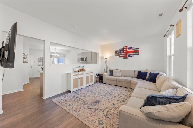 living room featuring a notable chandelier and hardwood / wood-style flooring