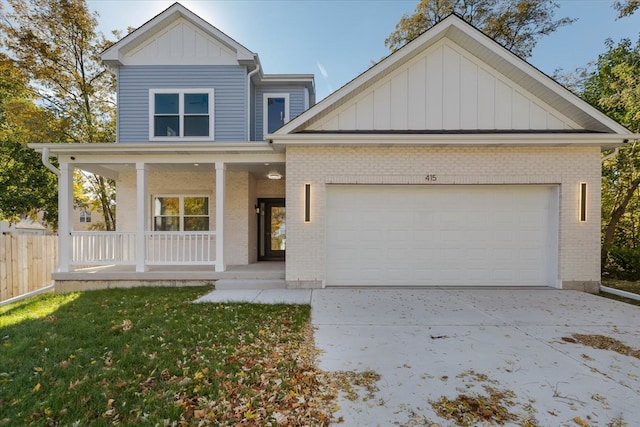 view of front of house with a porch, a front lawn, and a garage