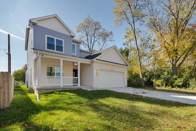 view of front facade featuring a front lawn, covered porch, and a garage