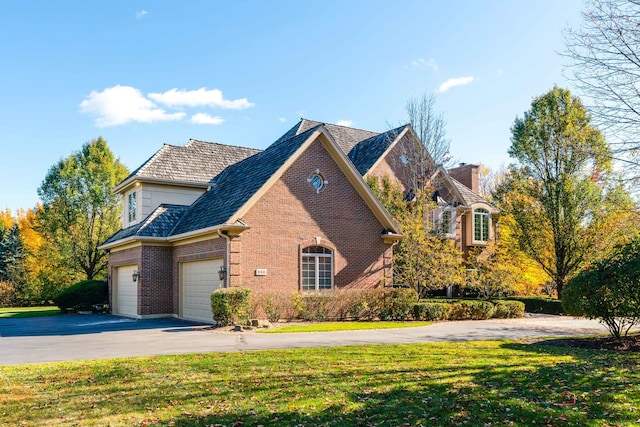 front of property featuring a front yard and a garage